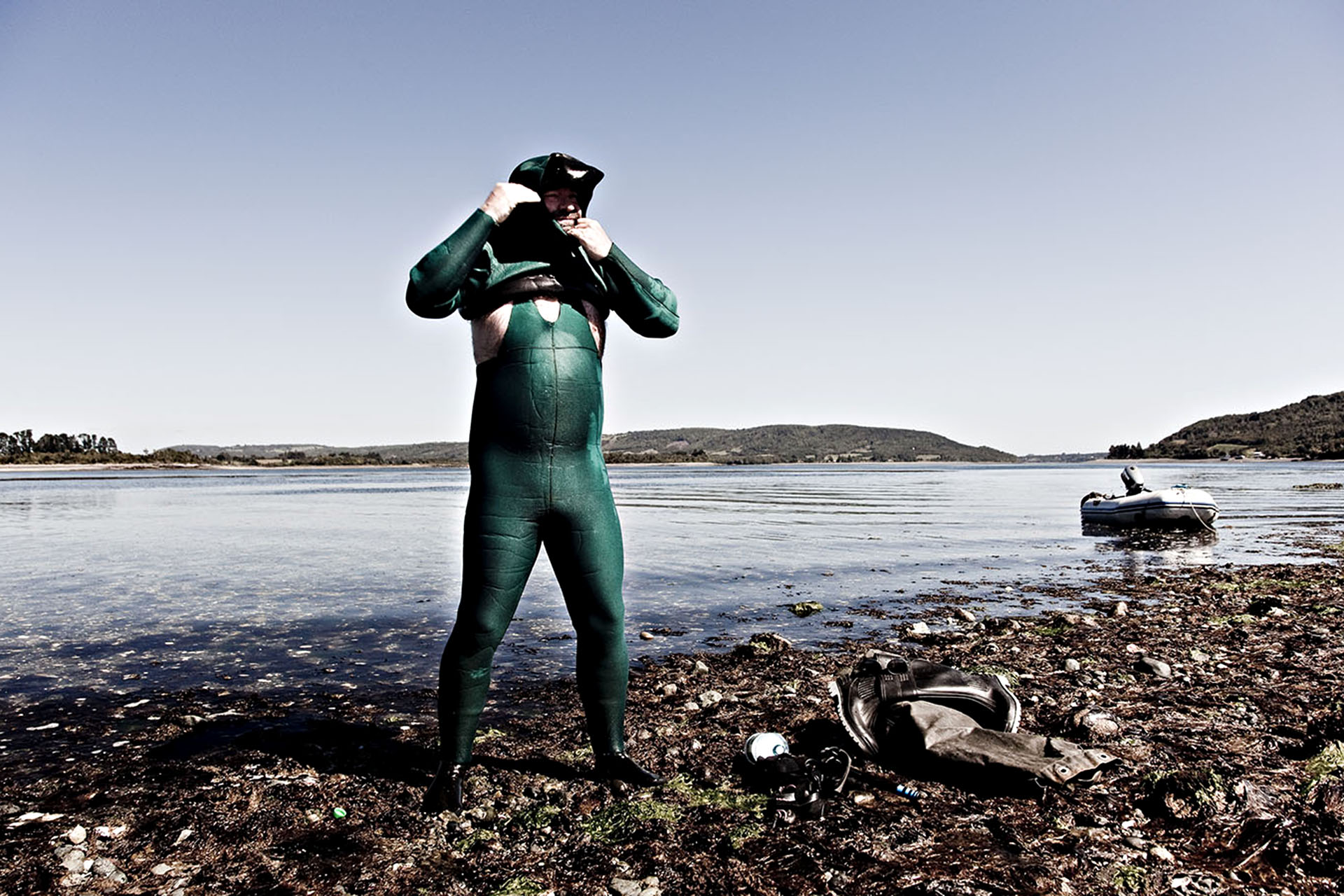 Carlos Lonza squeezes into his diving suit to collect fresh crustaceans.