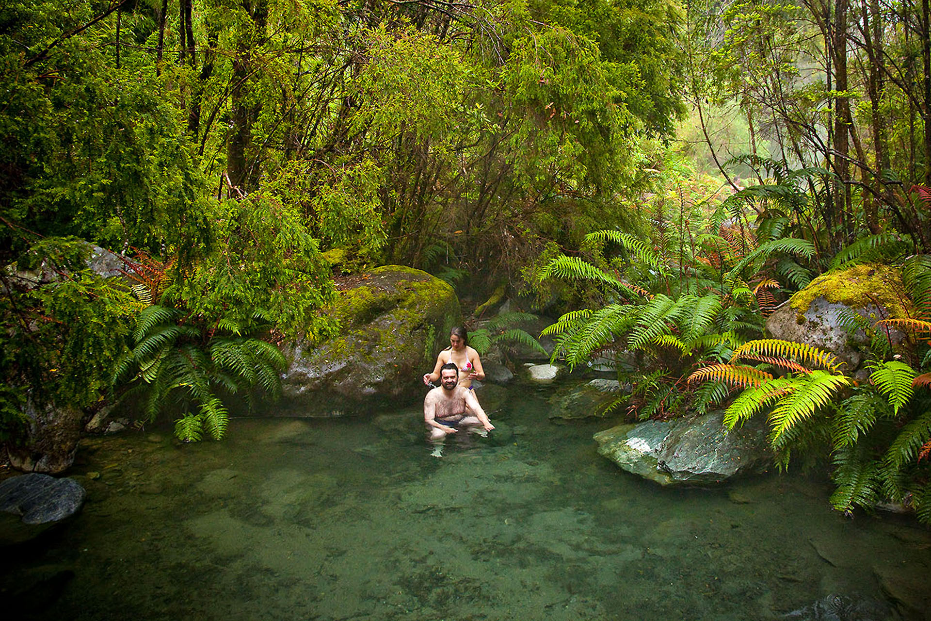 Carlos and Marlene relax in the secret hot springs near Porcelana.