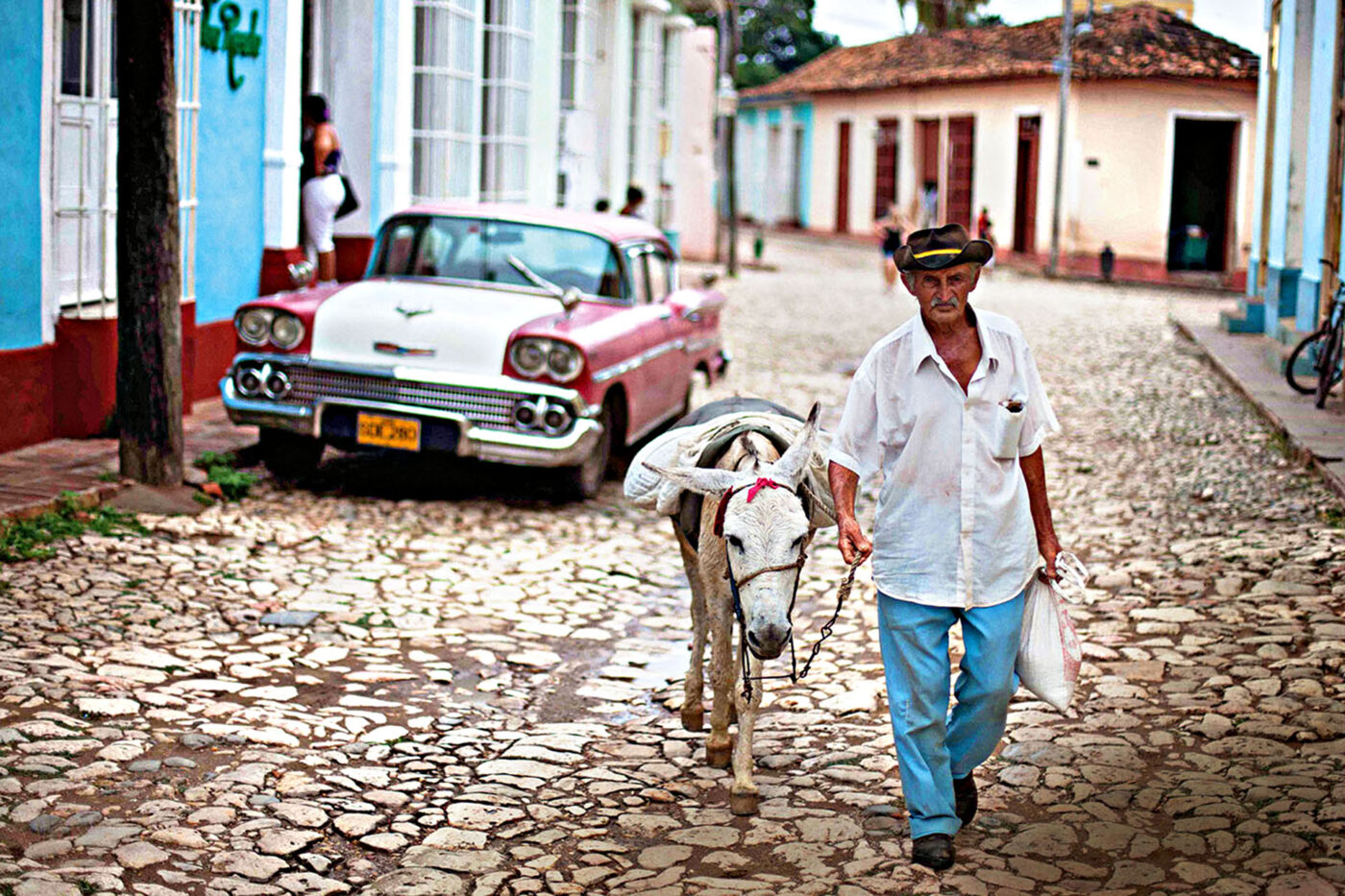 A man and mule wander the streets of Trinidad in the early morning.