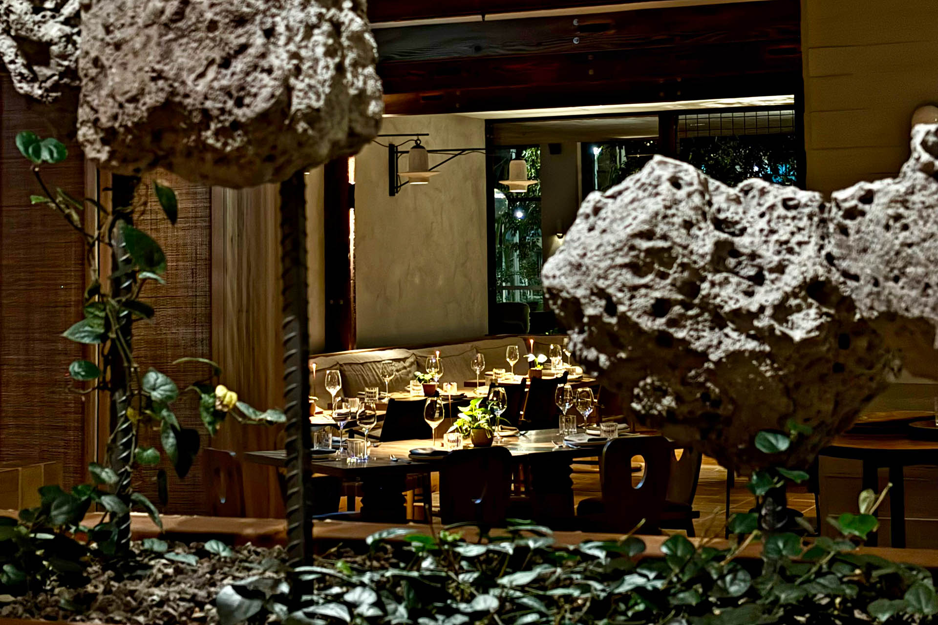Elegant restaurant dining room at 1 Hotel Melbourne framed by reclaimed timber and natural stone design elements.