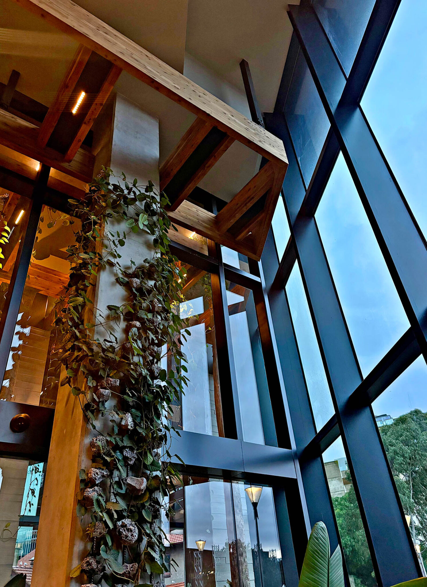 Sustainable timber architecture and living green wall inside the light-filled lobby at 1 Hotel Melbourne.