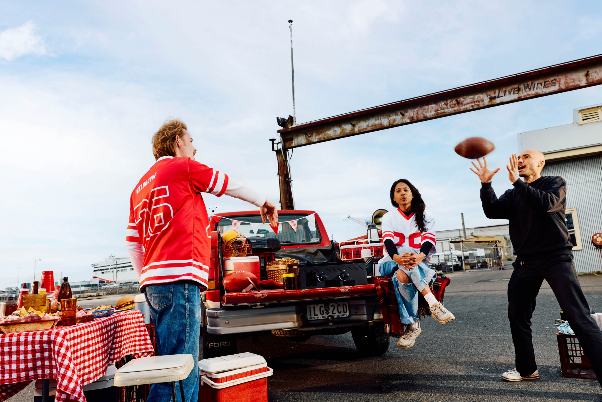 Alexander Volkanovski catches a football during Airbnb’s Aussie Tailgate experience at Seaworks in Melbourne.