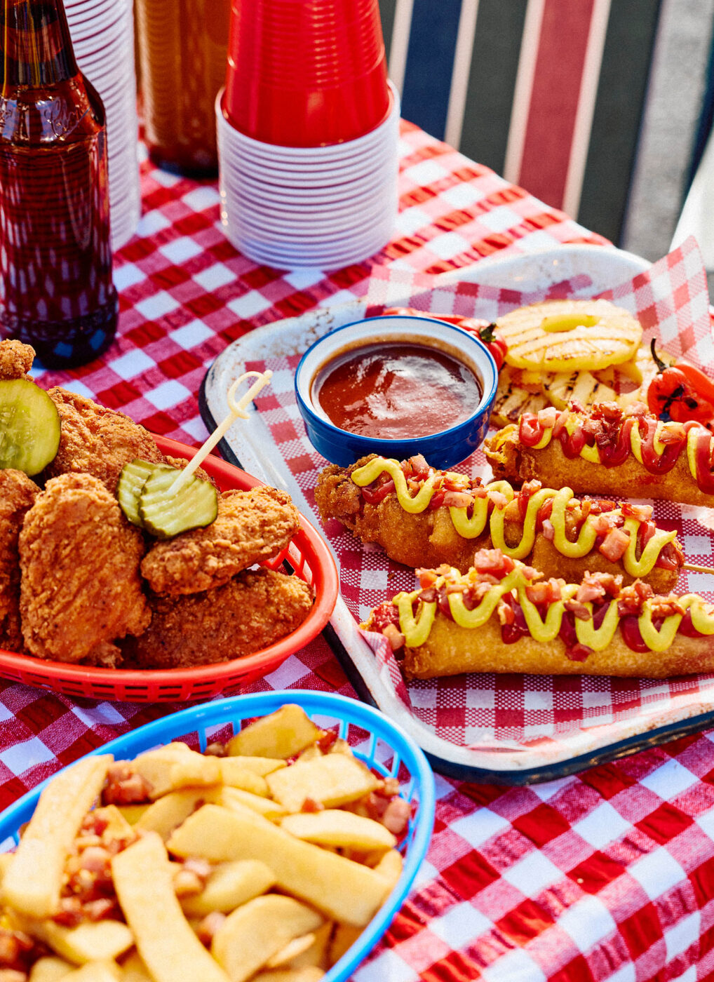 Hot dogs, fried chicken, grilled pineapple and dipping sauce served at Airbnb’s Aussie Tailgate event in Melbourne.