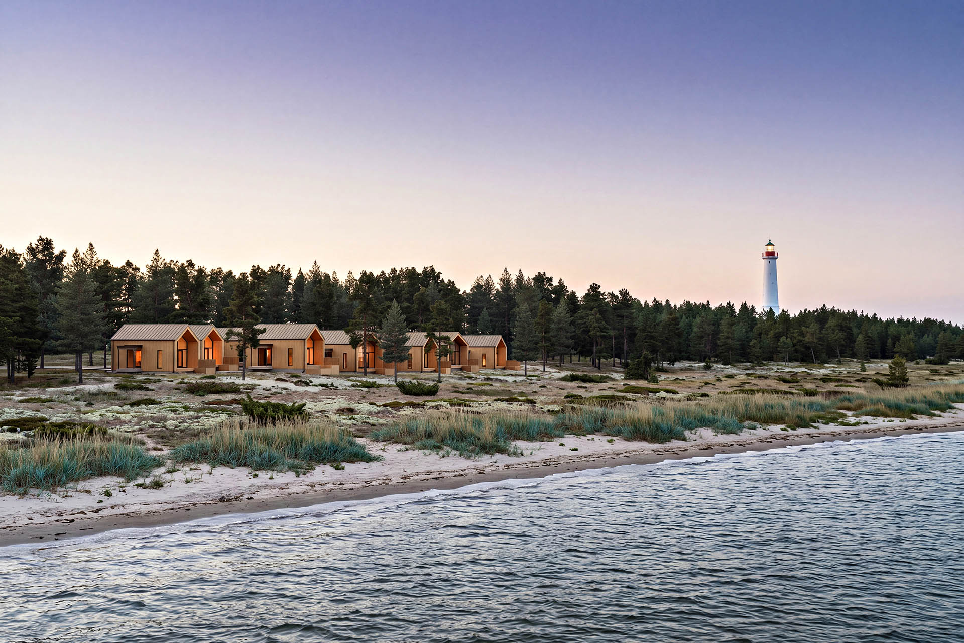 HALO Arctic Island's collection of Scandinavian-style cabins set along the shoreline near Hailuoto Lighthouse in Finland.