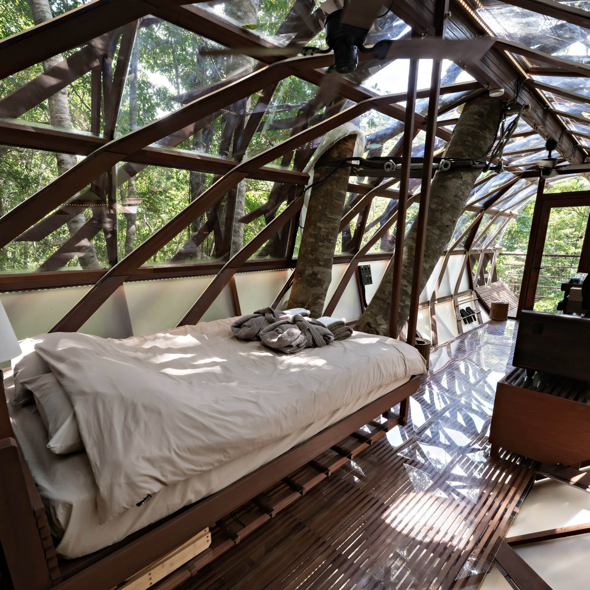 Double bed inside Treeful Floating Treehouse surrounded by subtropical forest in northern Okinawa.