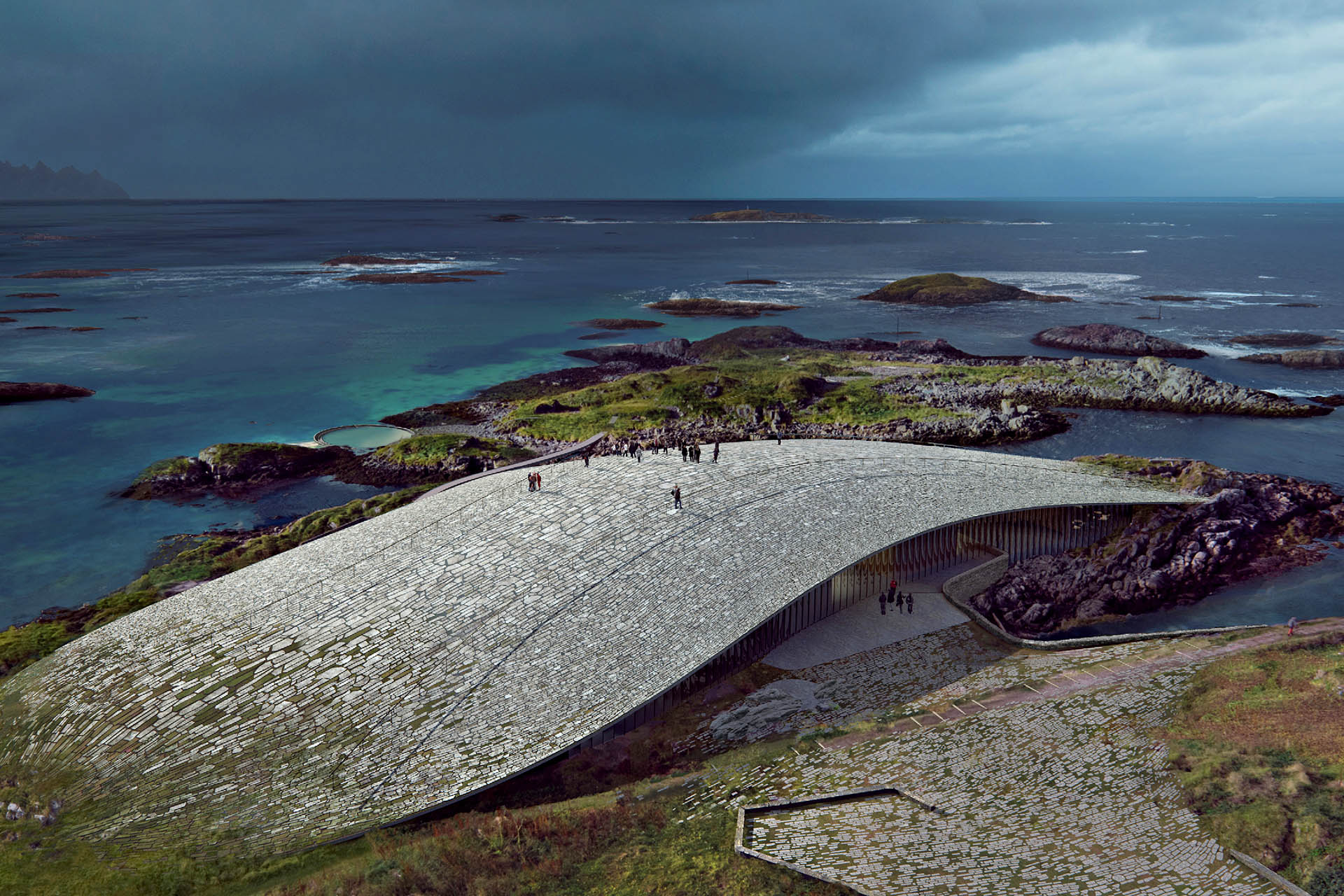 Aerial view of The Whale museum in Andenes, Norway, with its curved stone roof overlooking the dramatic Vesterålen coastline.