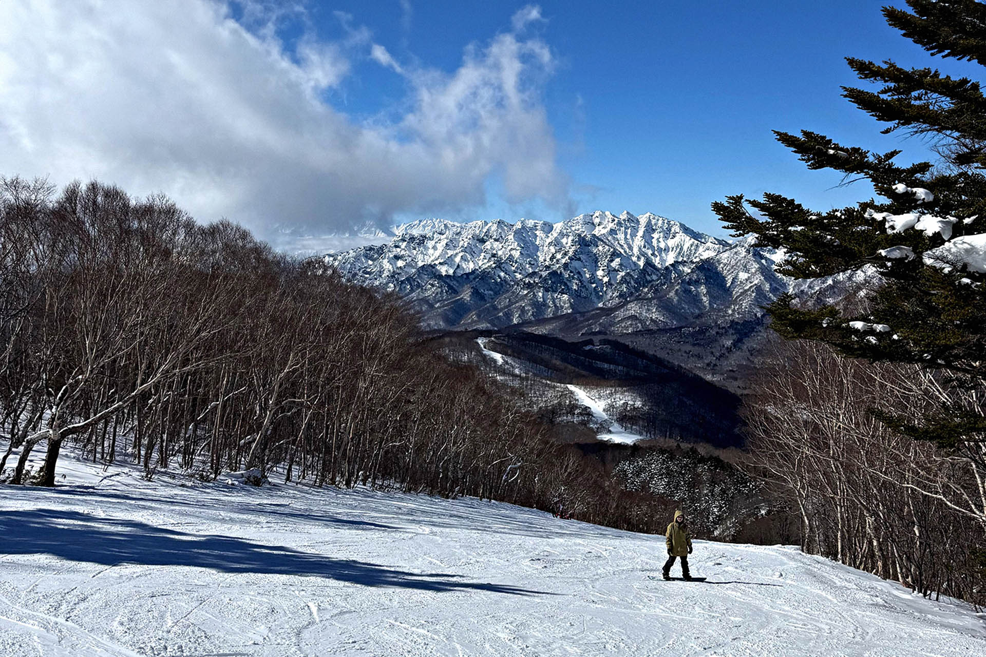 Snow-covered ski slopes beneath the Togakushi Mountain Range in Nagano, Japan.