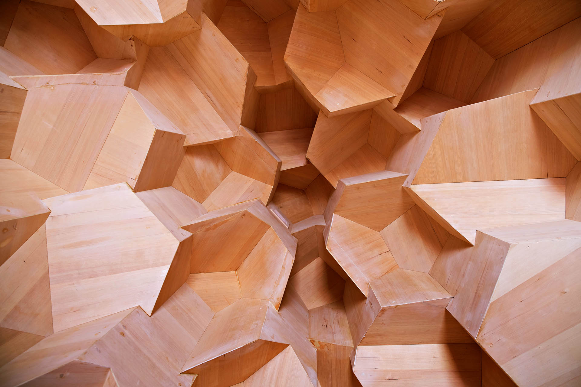 Geometric timber-lined interior of the Crystal Sauna at WasteLand Climate Action Park in Skellefteå, Sweden.