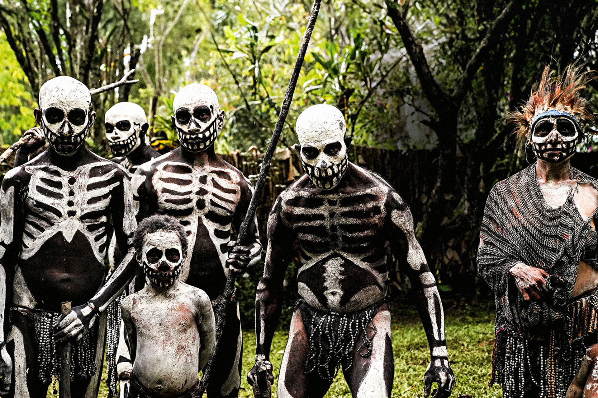 Skeleton dancers covered in striking black-and-white body paint during a traditional performance at Mindima Village, Papua New Guinea.