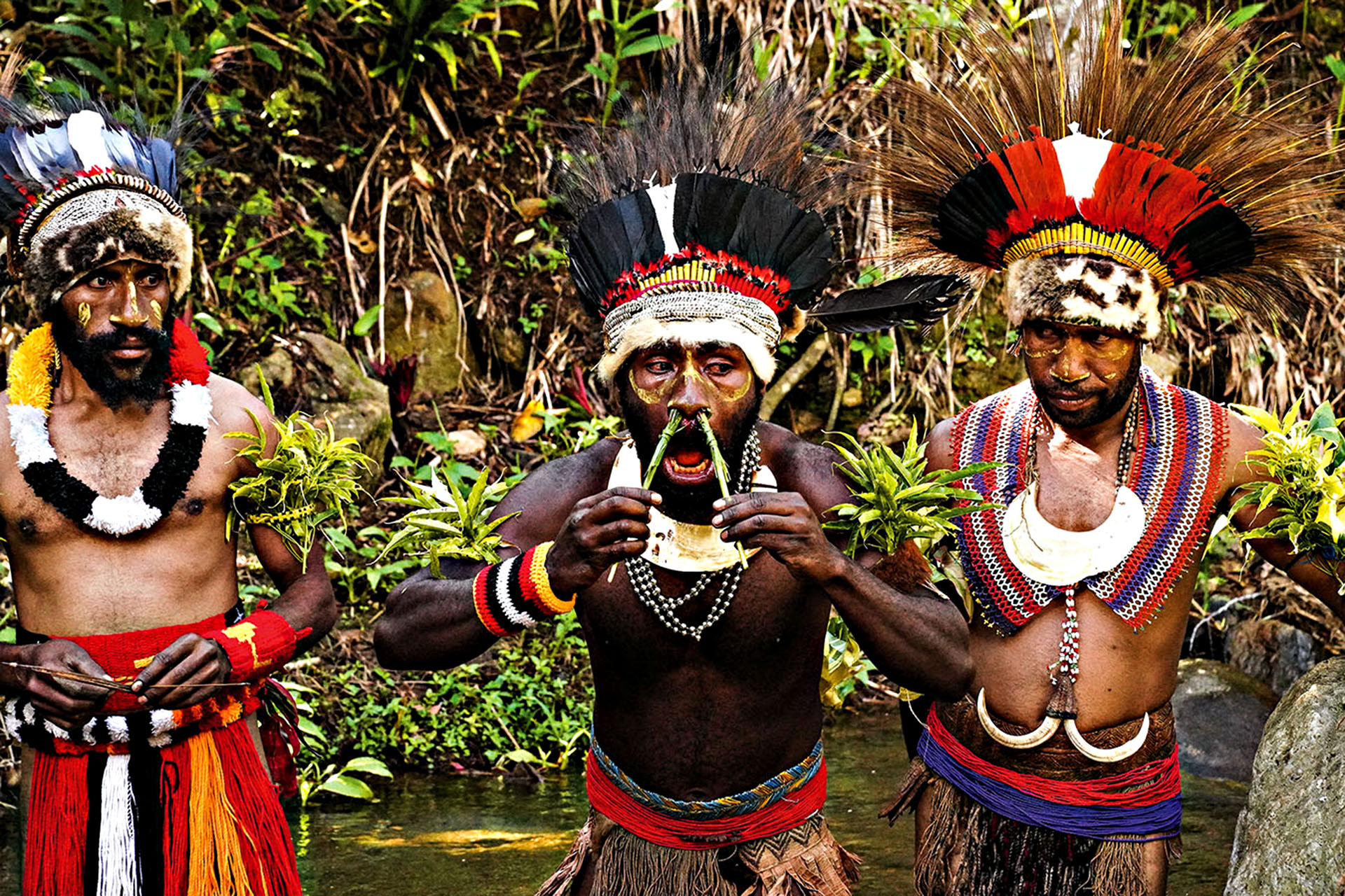 Keeya men wearing traditional headdresses, body paint and ceremonial dress at Safanaga Village in Papua New Guinea.
