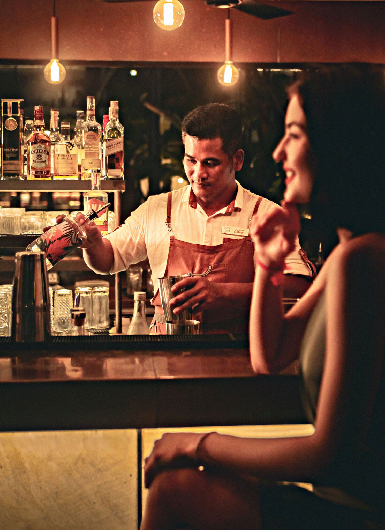 Bartender mixing a cocktail behind the bar at Scribe in Siem Reap, Cambodia.