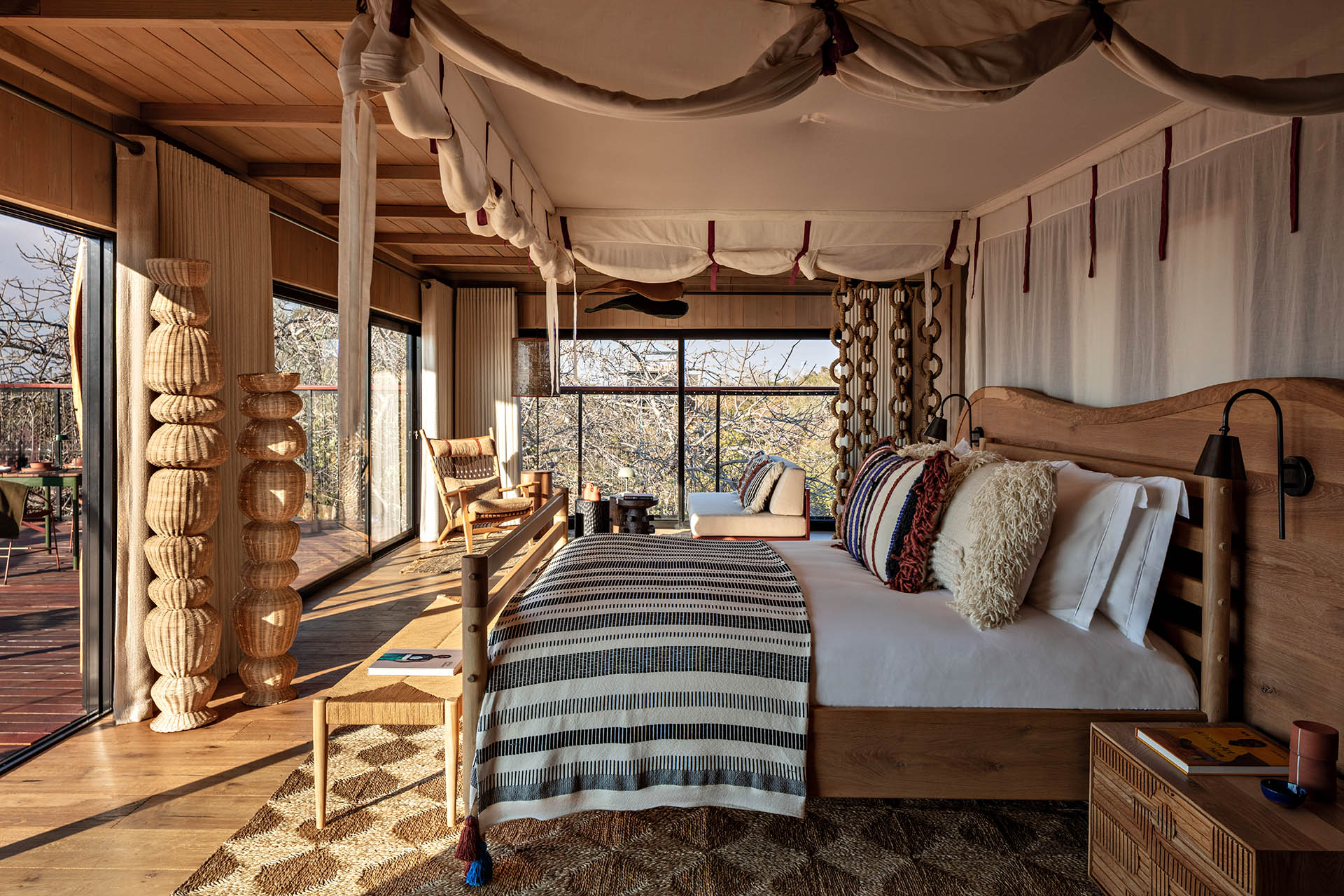Horizon Terrace Suite bedroom with treetop views at Anantara Kafue River Tented Camp in Zambia.