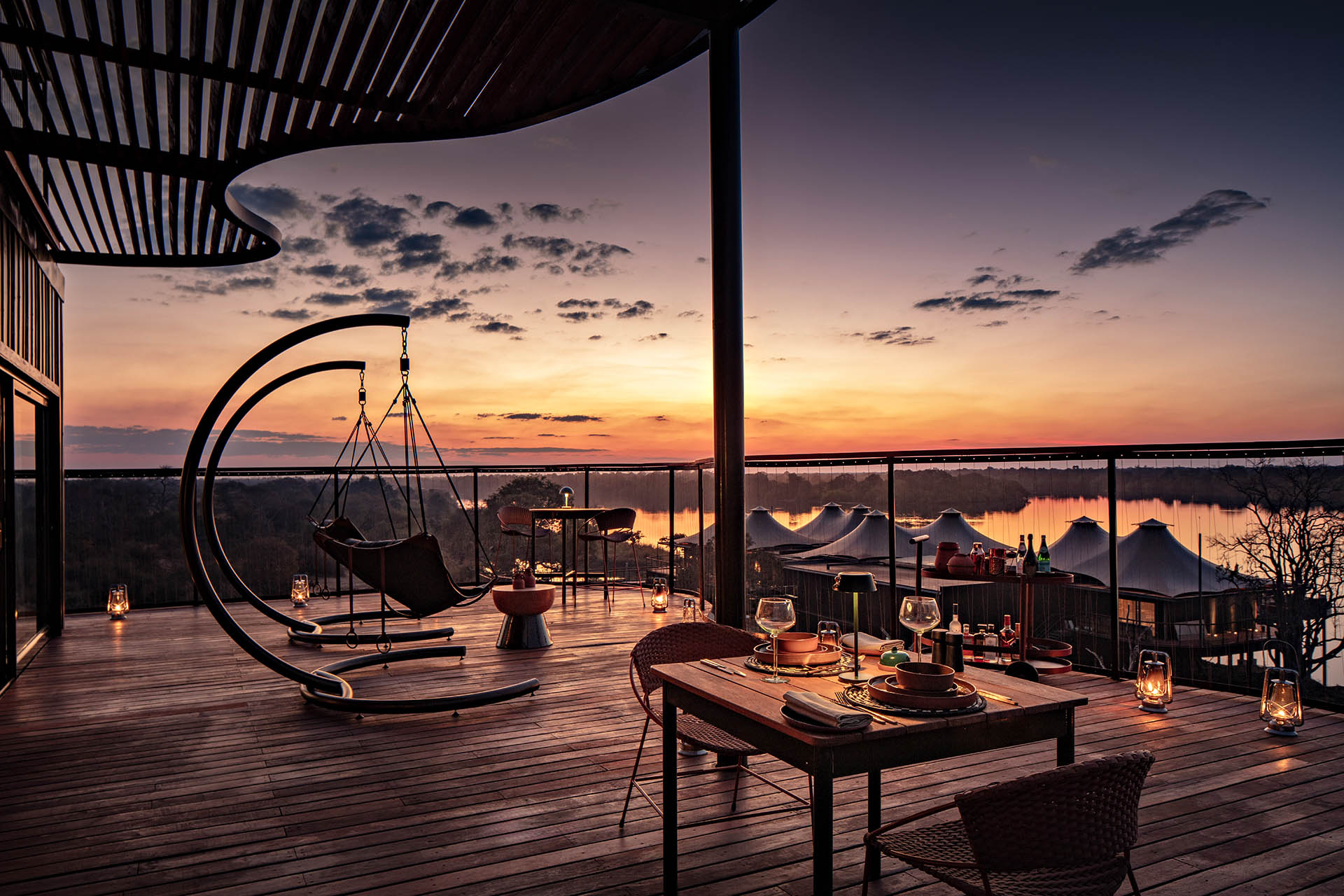 Private terrace at Anantara Kafue River Tented Camp overlooking the Kafue River at sunset in Zambia.