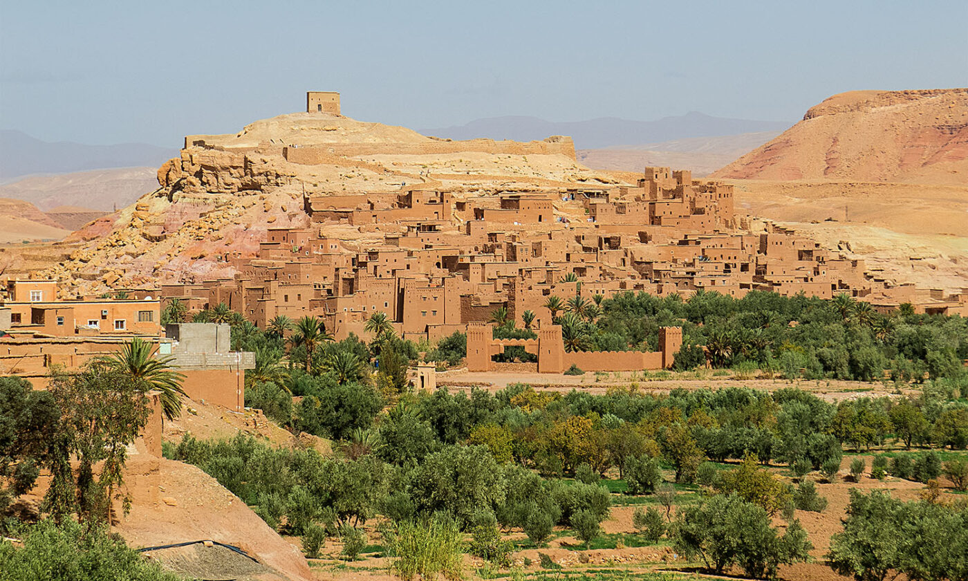 The city of Aït Benhaddou blends into the hillside from afar.