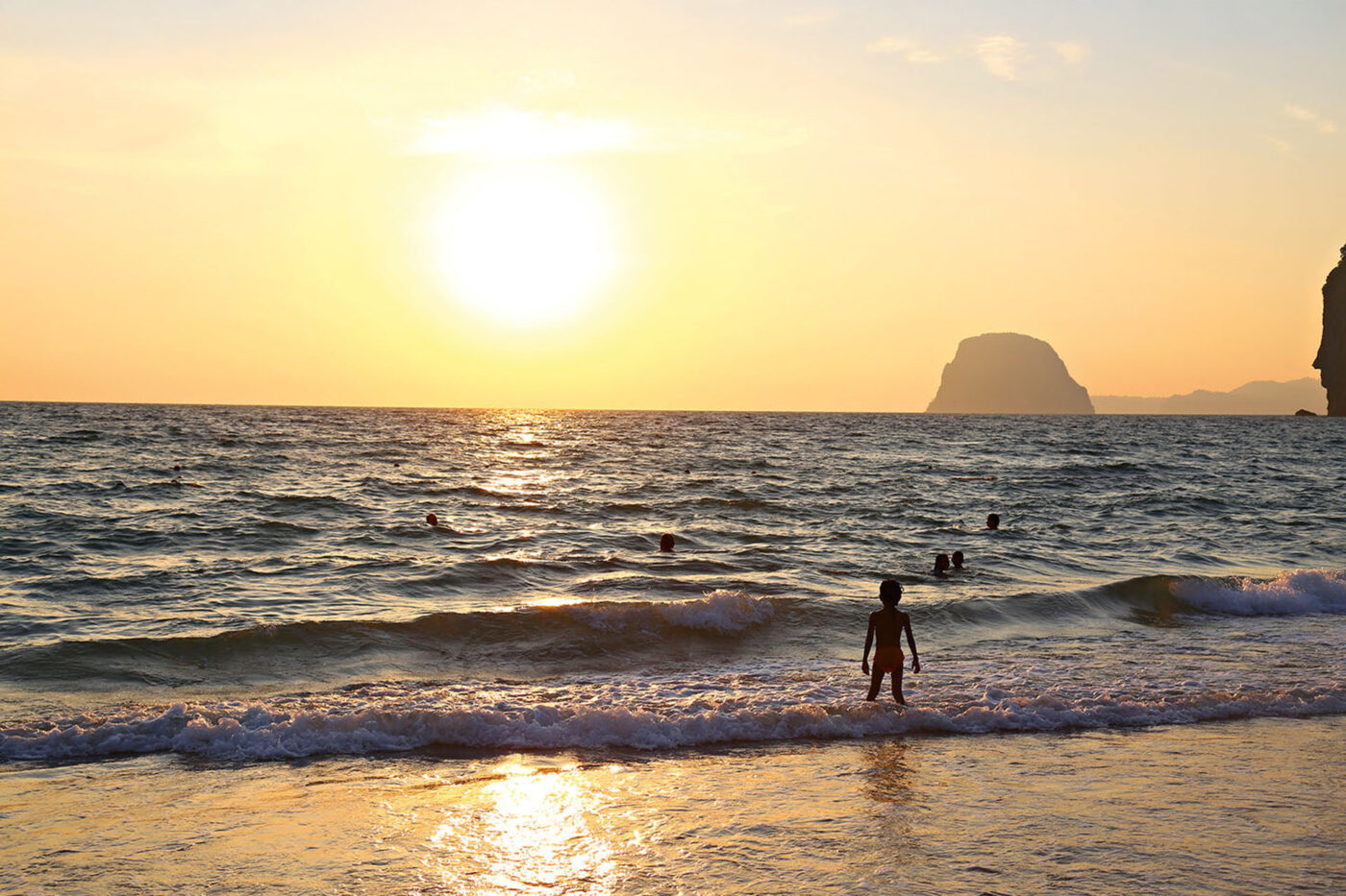 Children play in the waves at one of Koh Mook’s beaches.