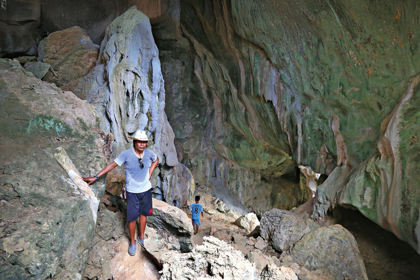 Suriya Hadden and his son in the cave system that leads to Point Dugong.