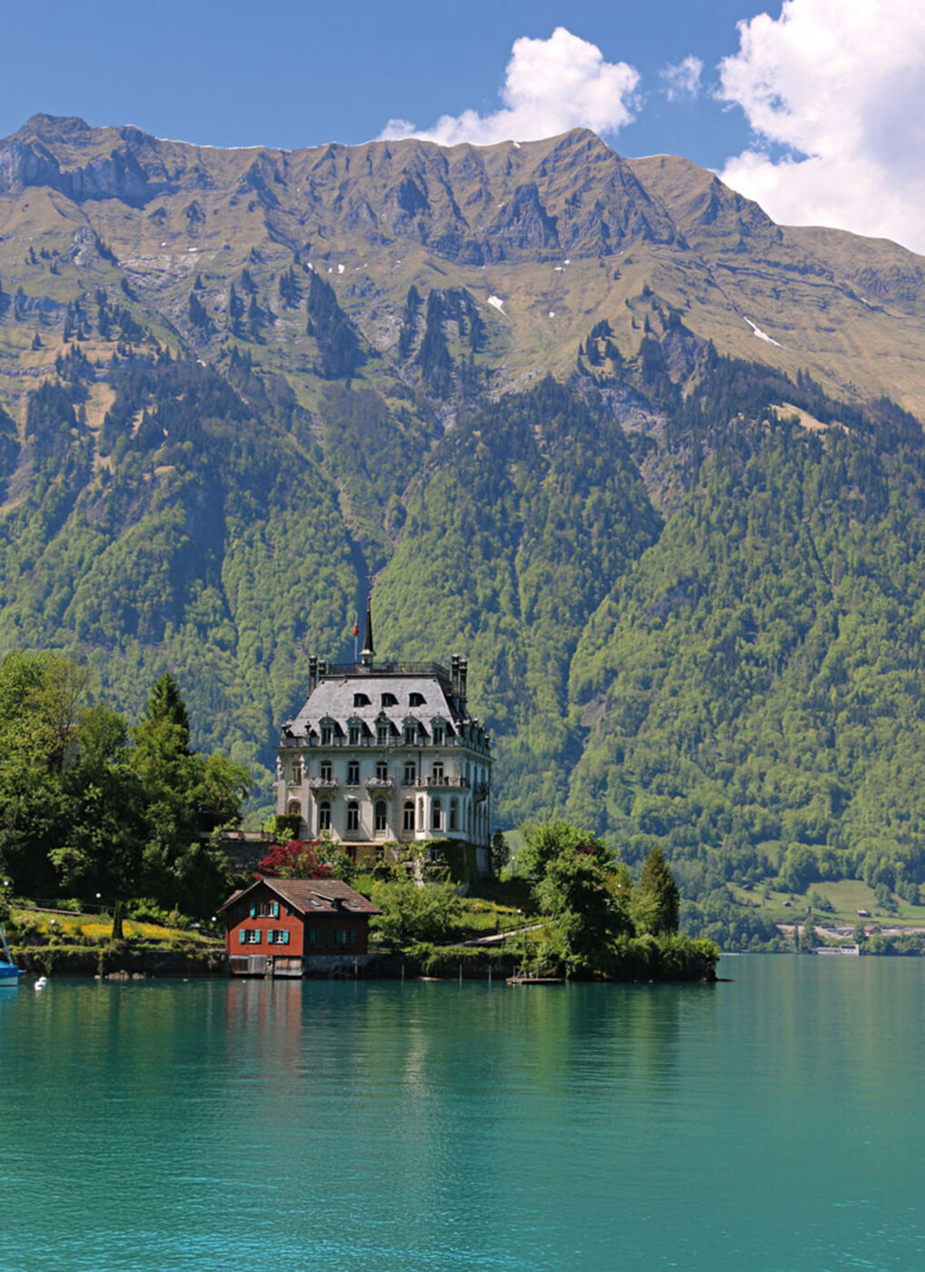 The fairytale-worthy Iseltwald Castle sits on a peninsula surrounded by the turquoise waters of Lake Brienz.