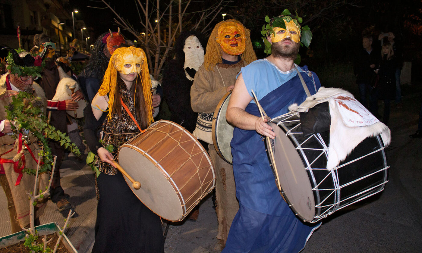 Pagans celebrate by banging drums and playing bagpipes as they lead the procession.