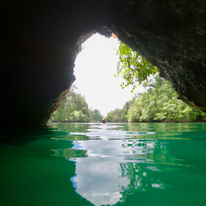 Kayaking through a cave passage.
