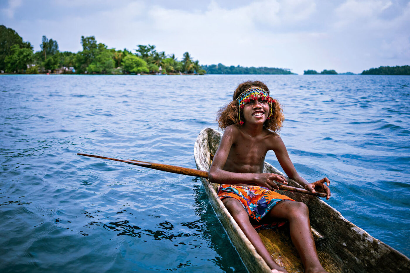 A local child in a dug-out canoe.