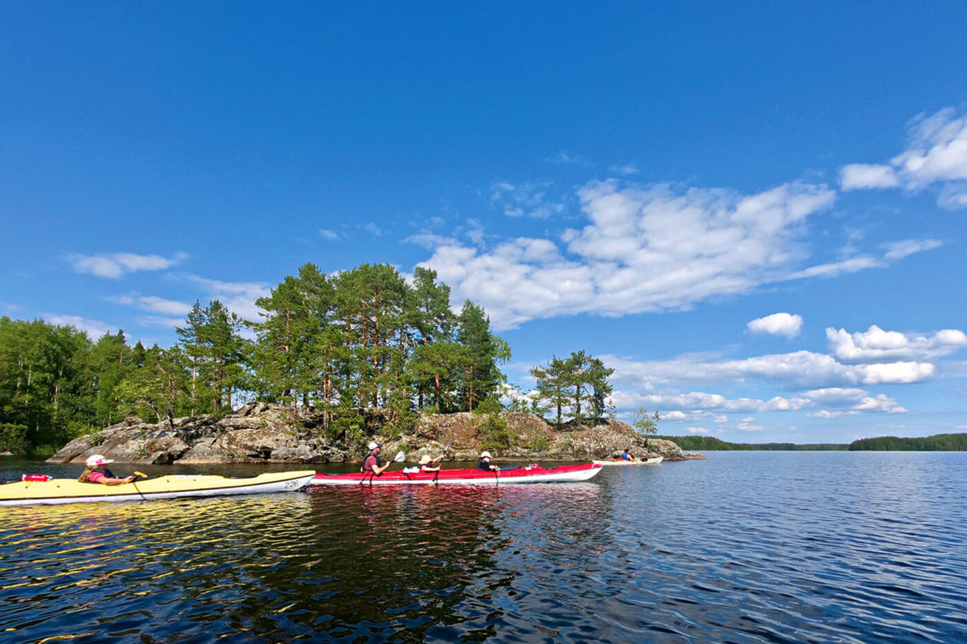 Pass uninhabited islands on a kayak tour of Lake Saimaa.