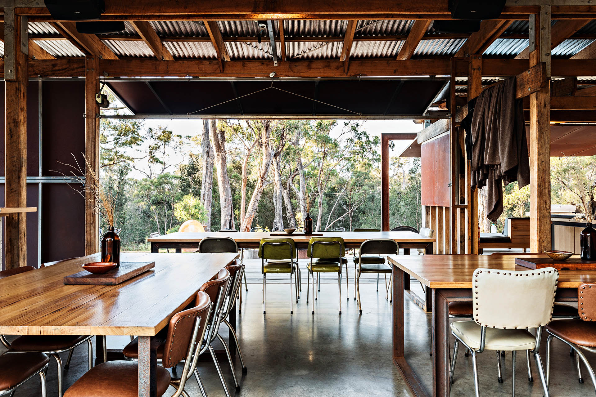 Communal kitchen and dining pavilion overlooking the bush at Bay of Fires Bush Retreat in Tasmania.
