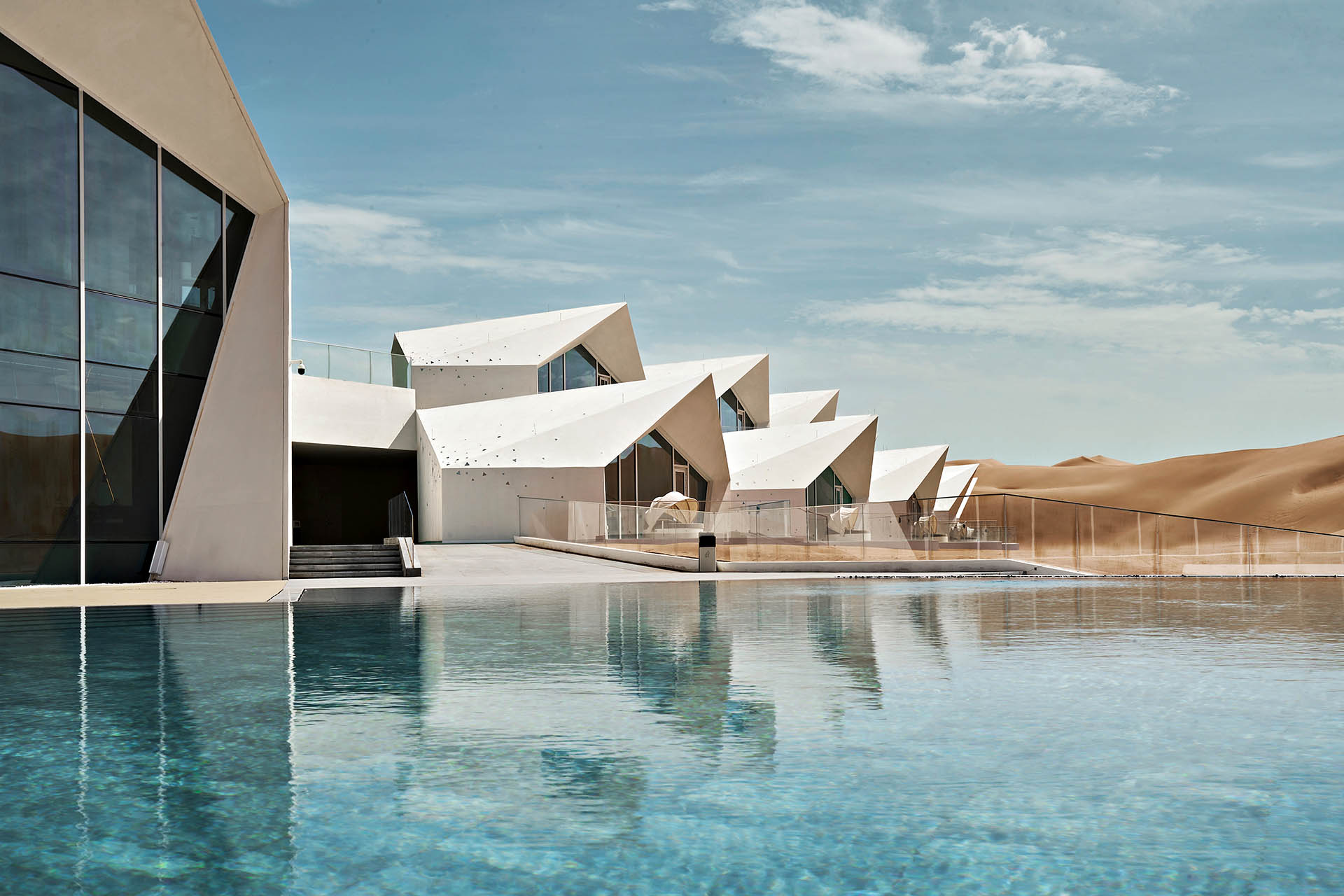 Swimming pool and angular white villas at ZhongWei Desert Diamond Hotel in Zhongwei, China.