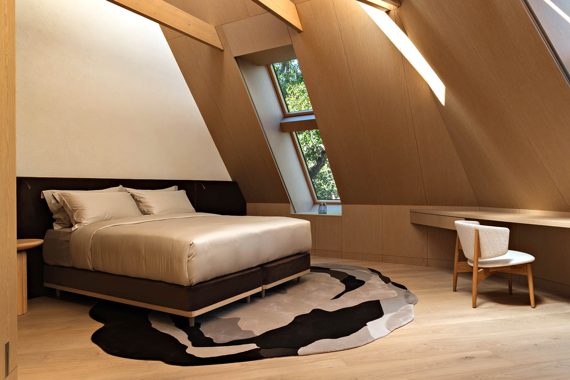 Wood-lined bedroom inside a suite at Eha Retreat on Hiiumaa Island, Estonia.