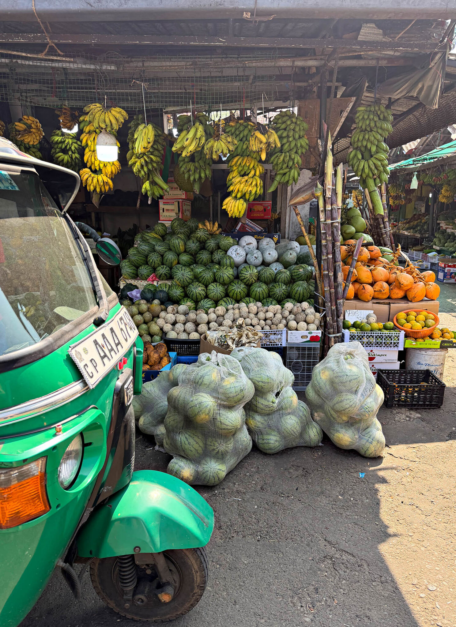 Fruit market with bananas, watermelons and coconuts in Sri Lanka.