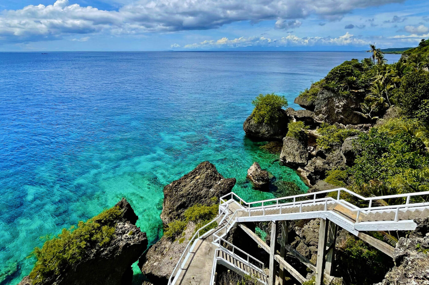 Rocky tropical coastline and turquoise water on Siquijor Island in the Philippines.