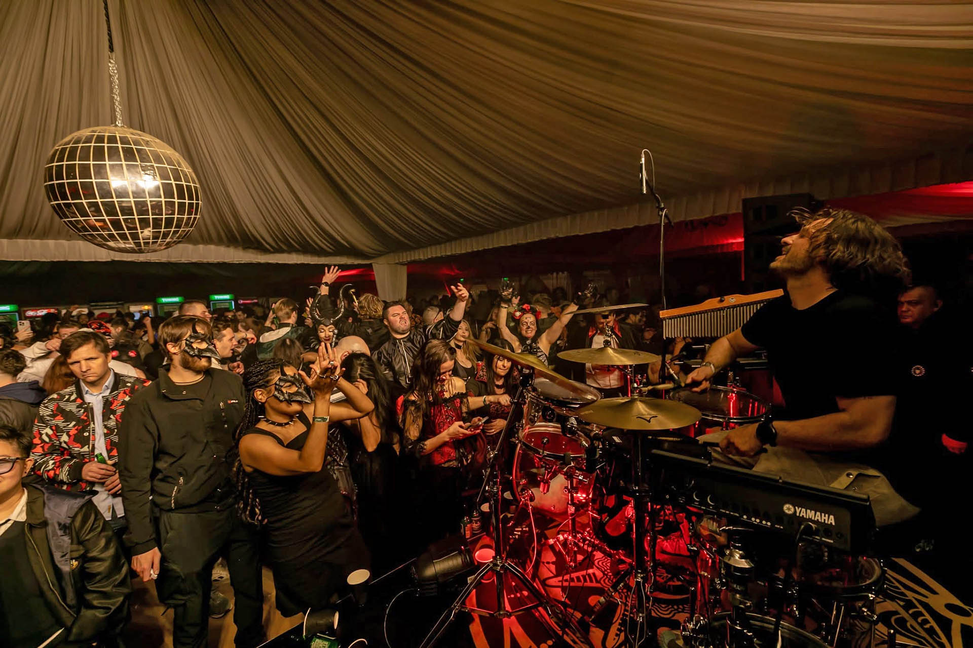 Drummer performs for a packed crowd during Halloween celebrations in New Orleans.