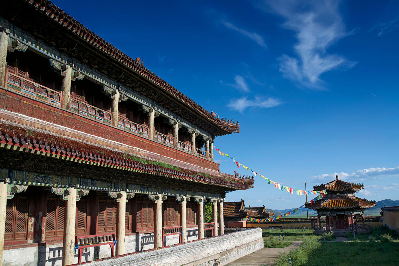 A red Mongolian temple, contrasted by a deep blue sky.