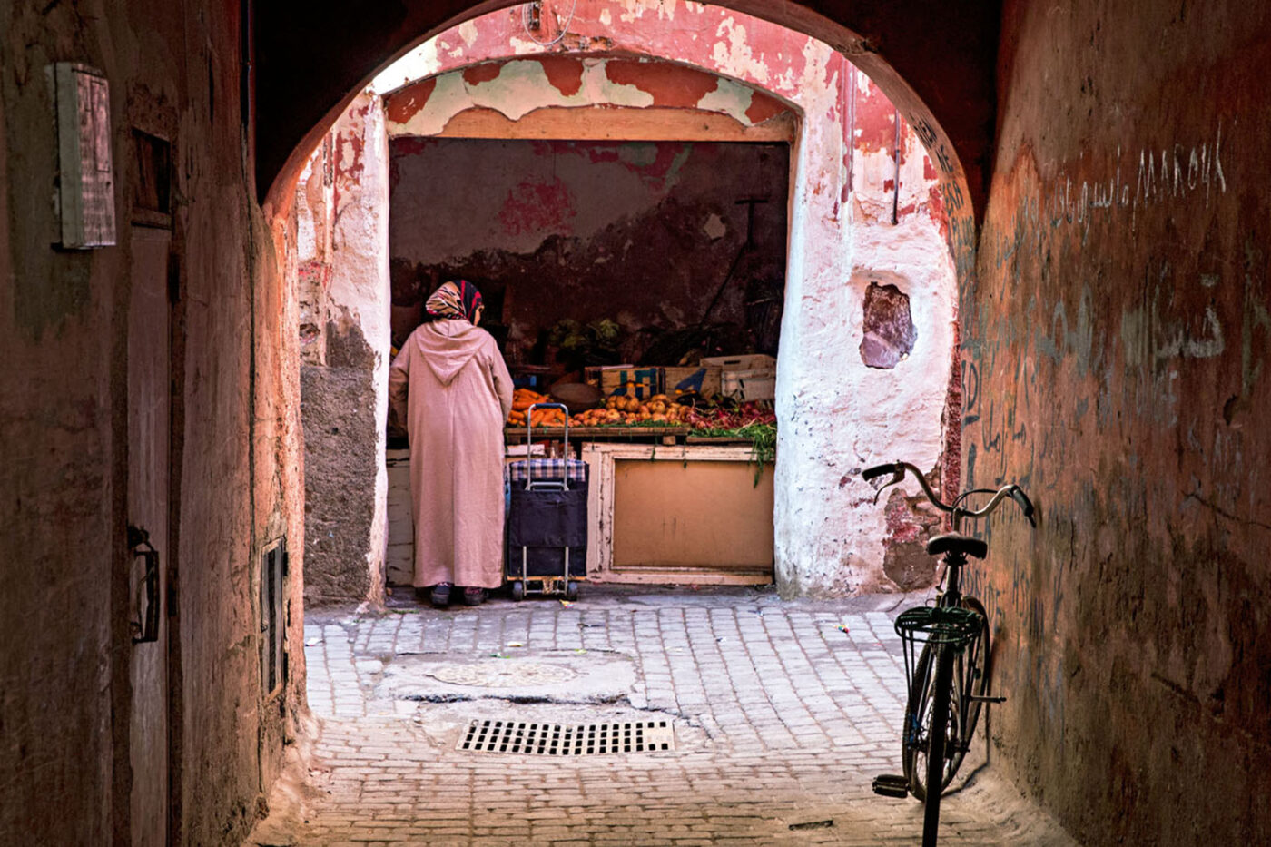 A view of one of the alleyways, with peeling paint, cobbled streets, exposed brick and myriad archways in every shape and colour