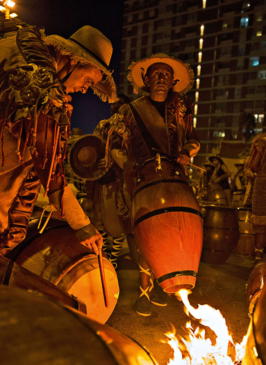 Drummers warm the leather on their drums to make it more pliable.