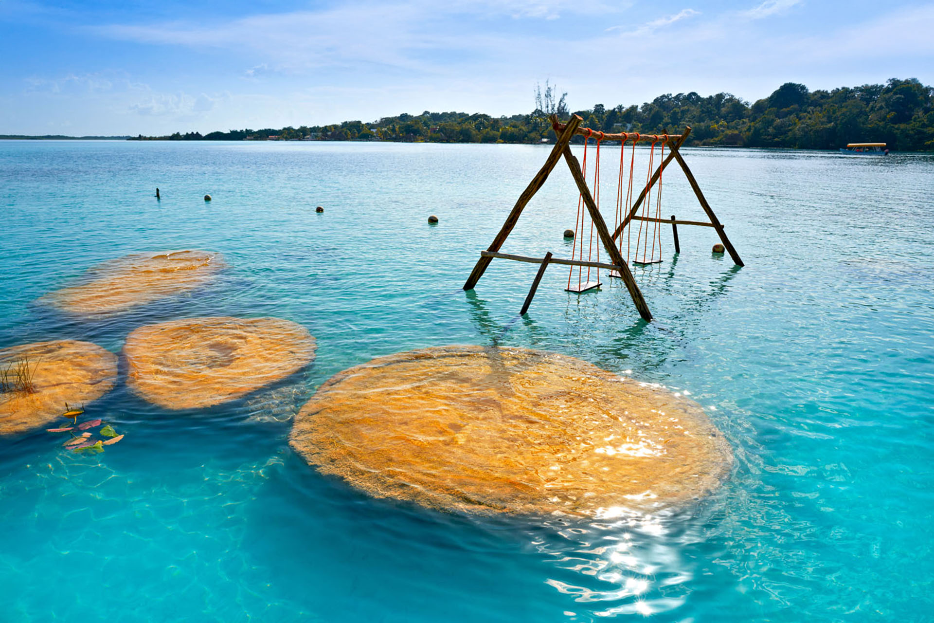 A swing set in the blue water.