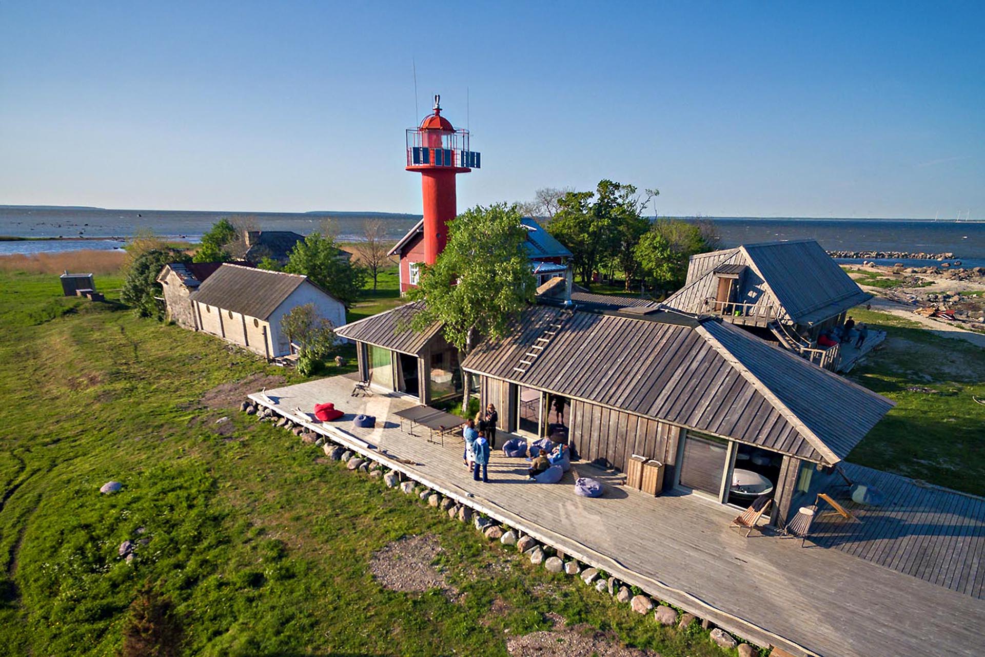 A red lighthouse by the sea.