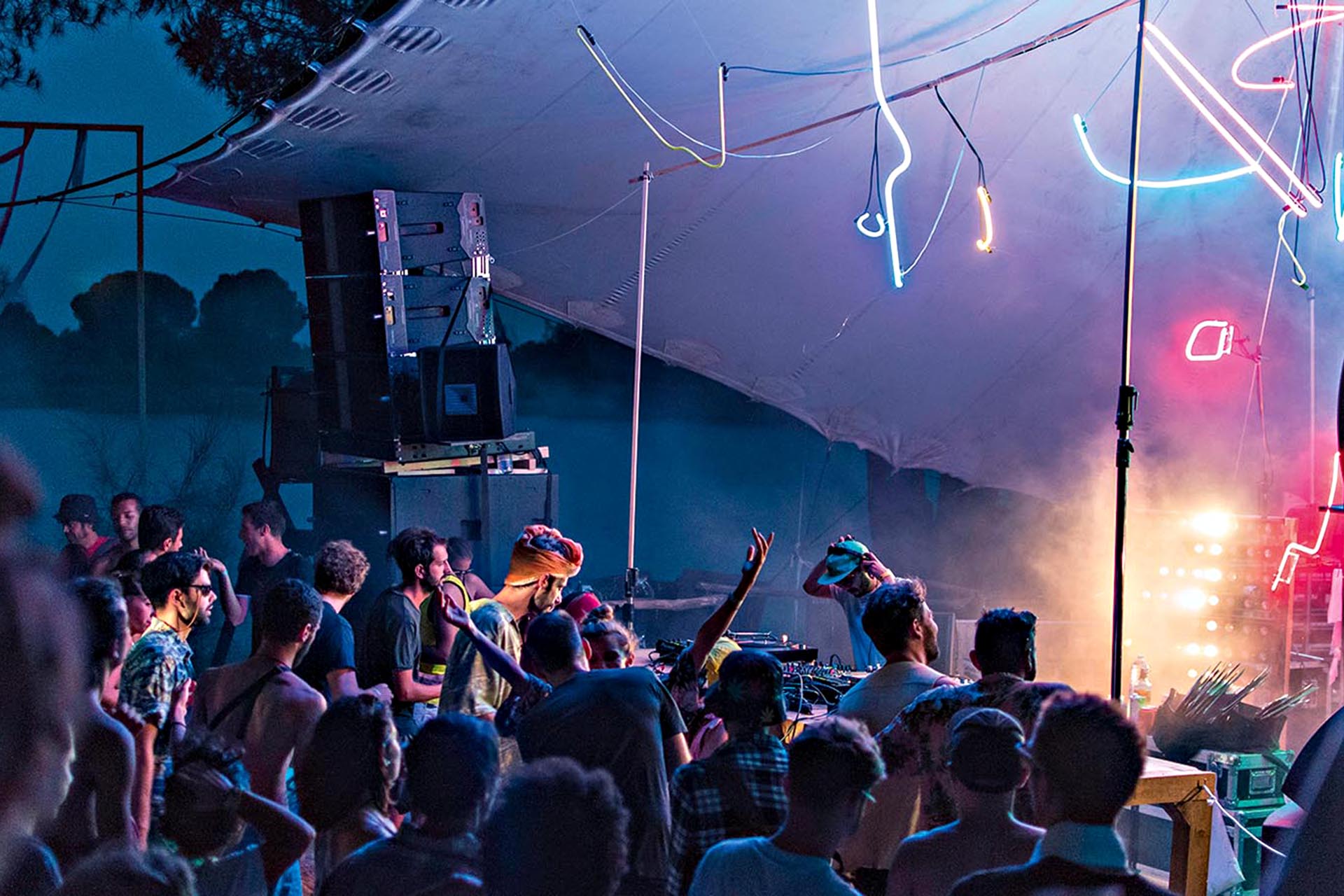 A big crowd at a neon-lit festival.