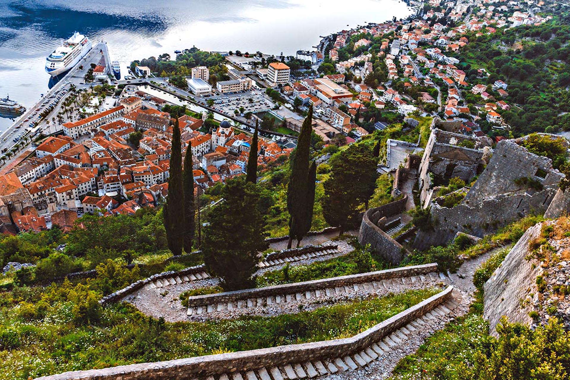 The view of a town with red roofs from a mountain.