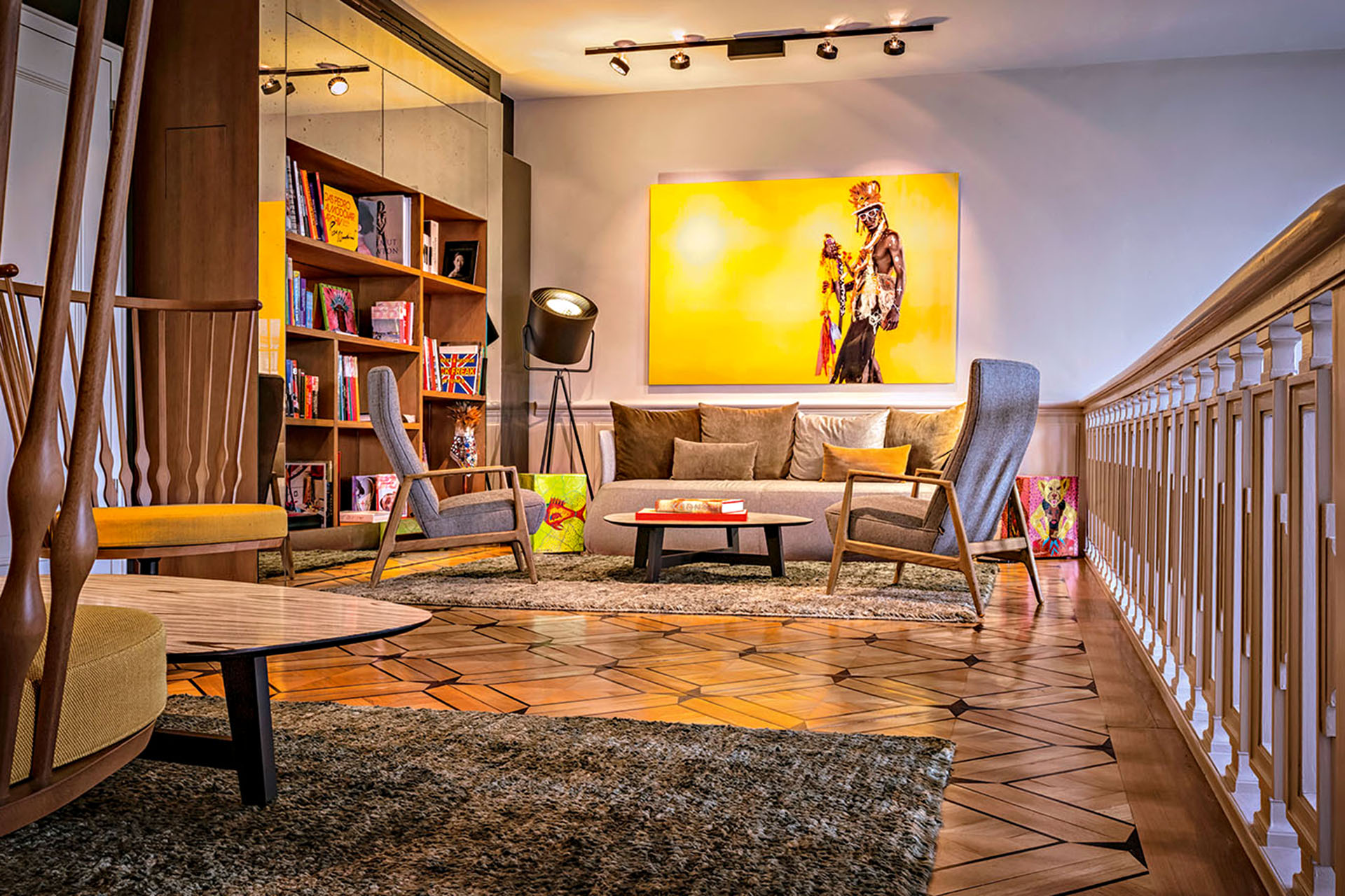 A living room with a yellow painting and modern decor.