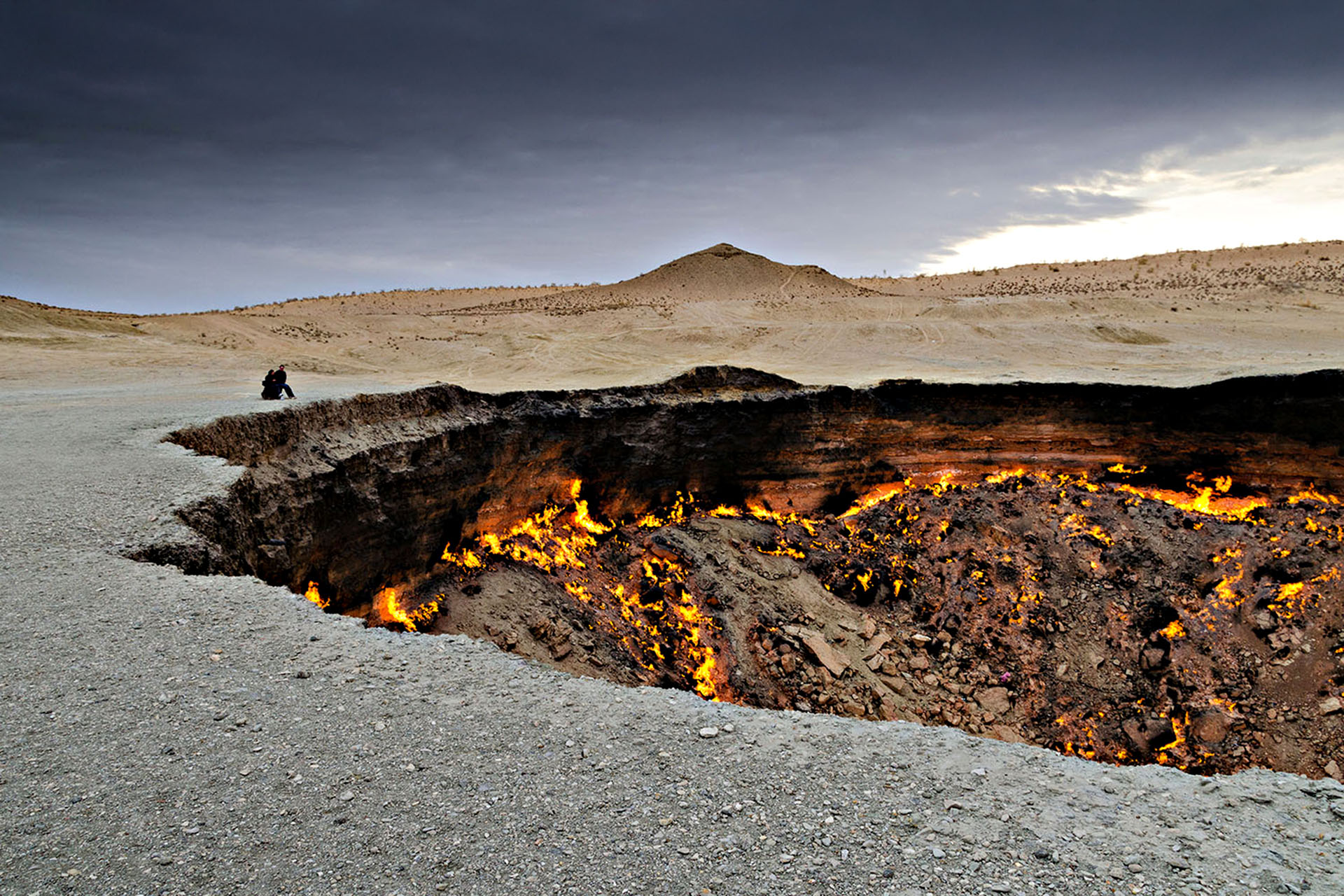 A giant gas grater filled with flames, surrounded by desert.