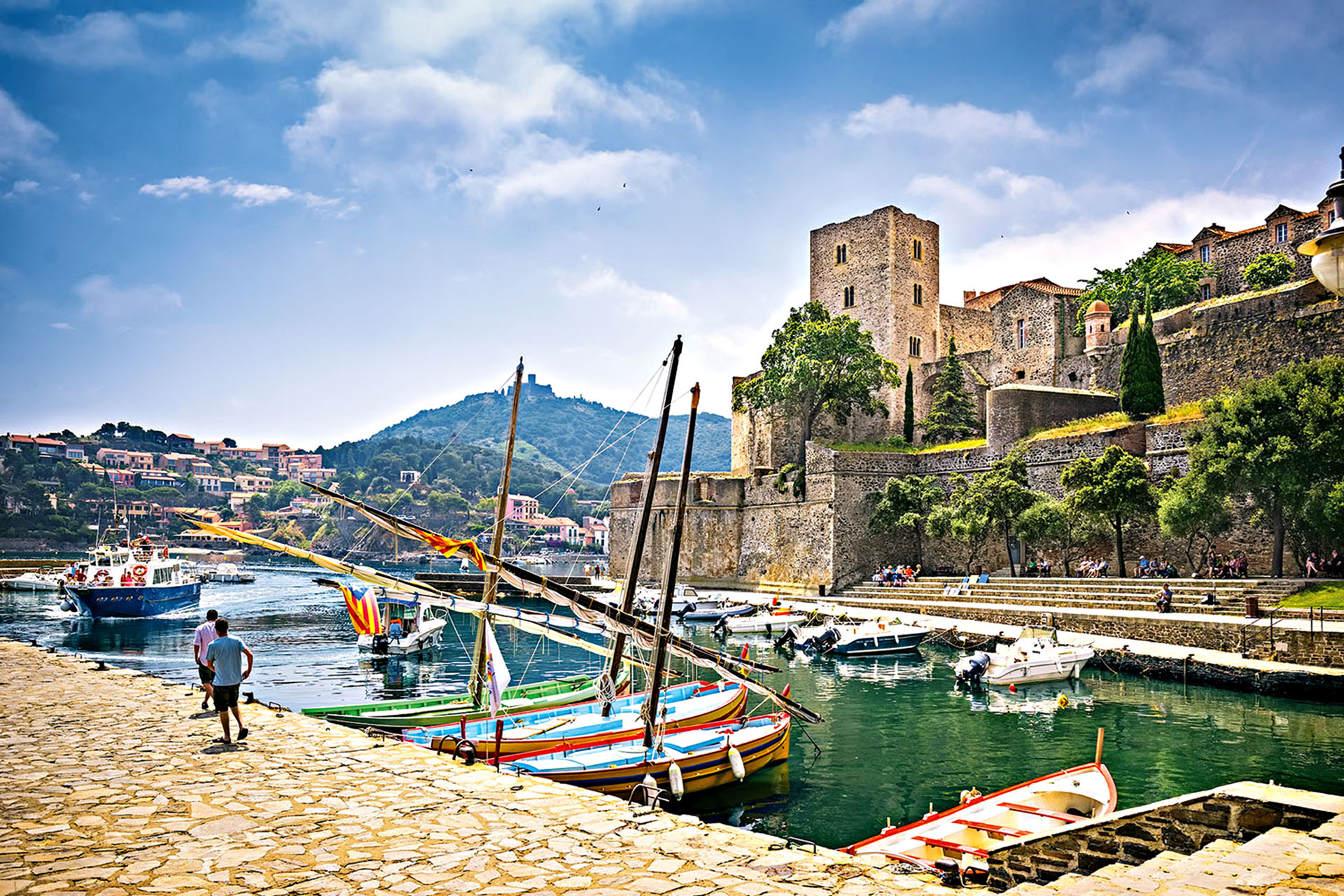 A harbour in France with small boats parked.