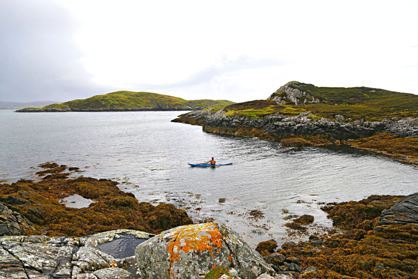 A person in a kayak in the middle of the water.