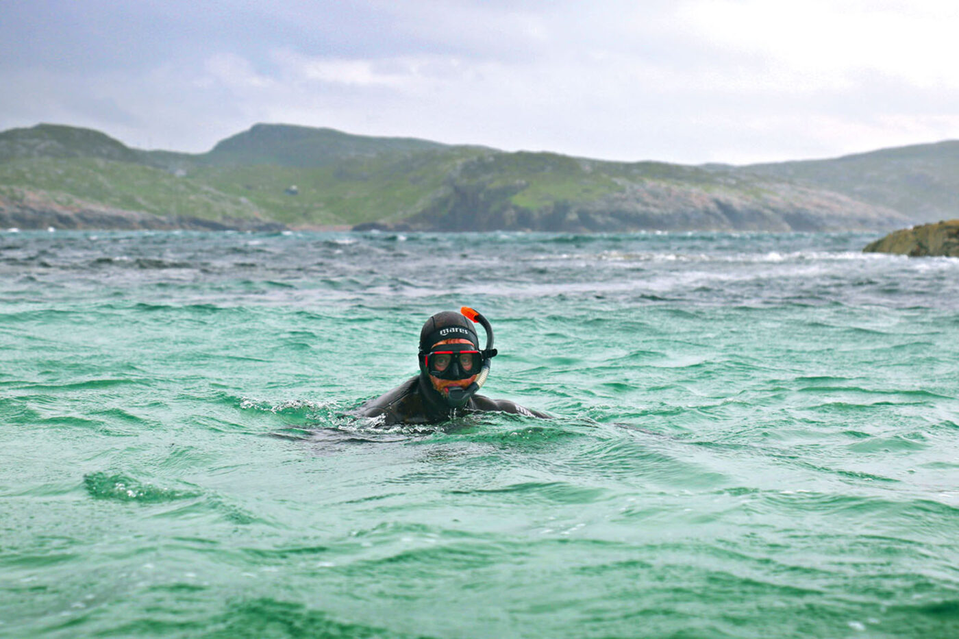 A person with a snorkel in the water.