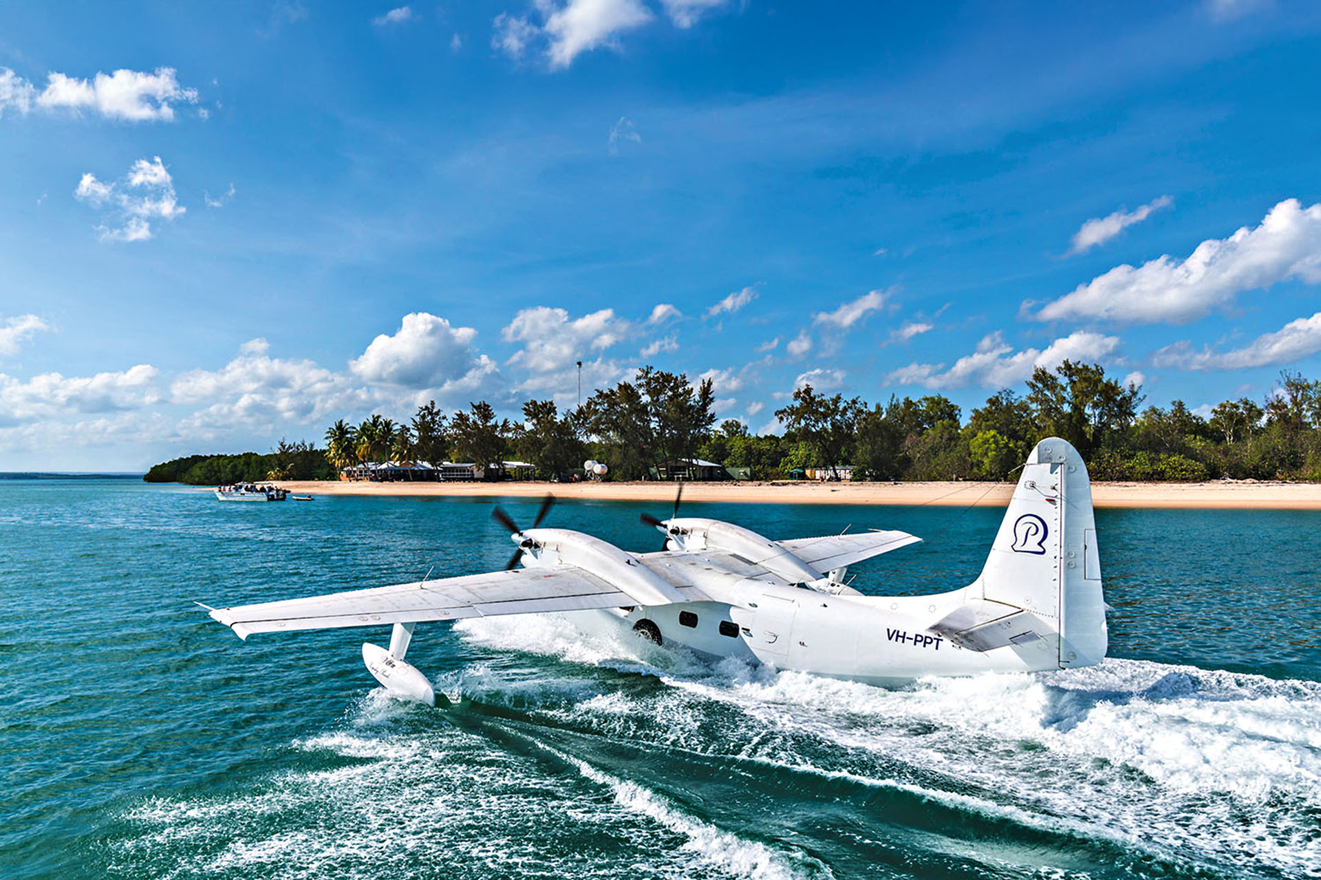 A seaplane coming into shore at the island.