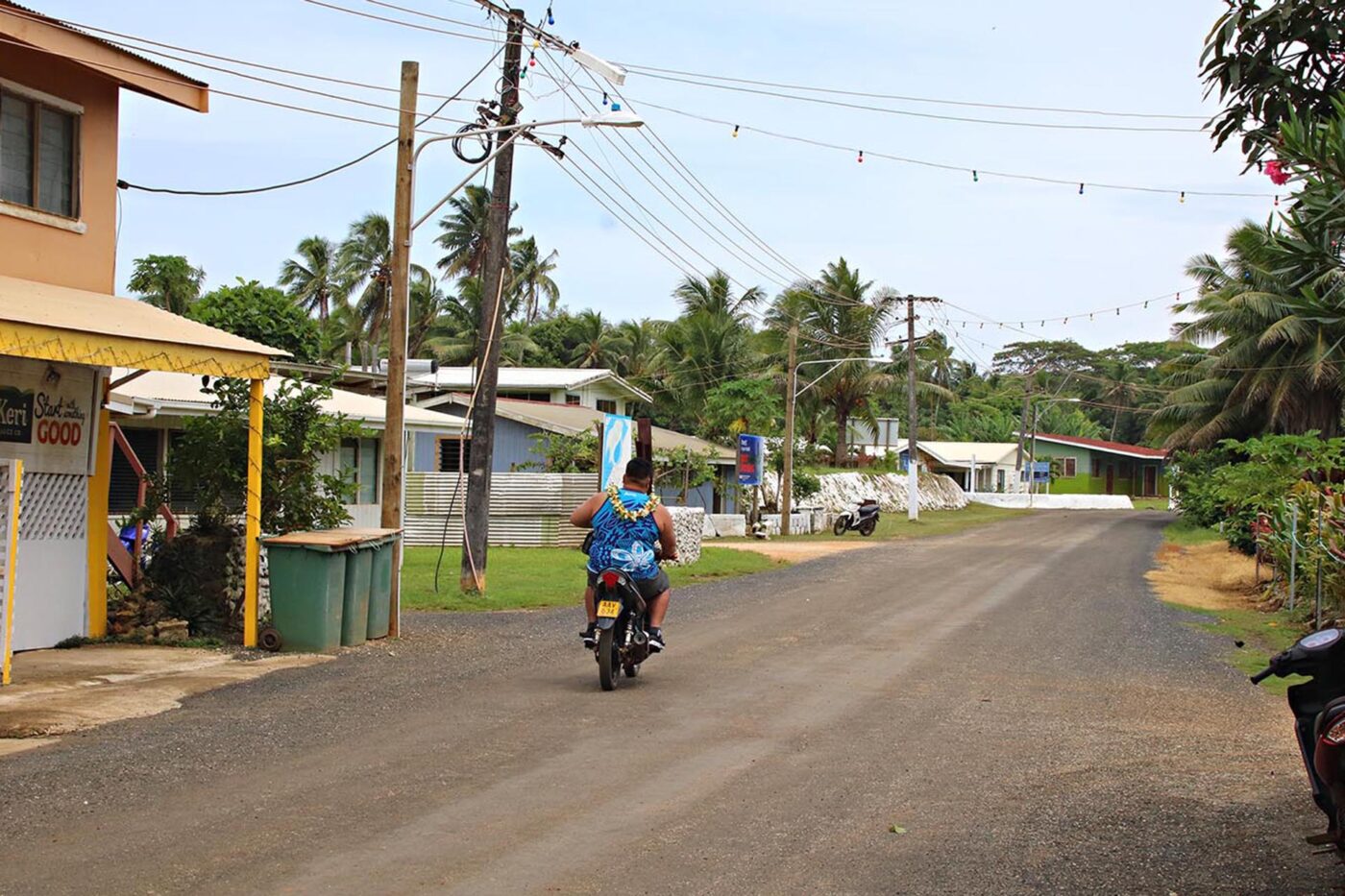 A person riding a scooter down the street.