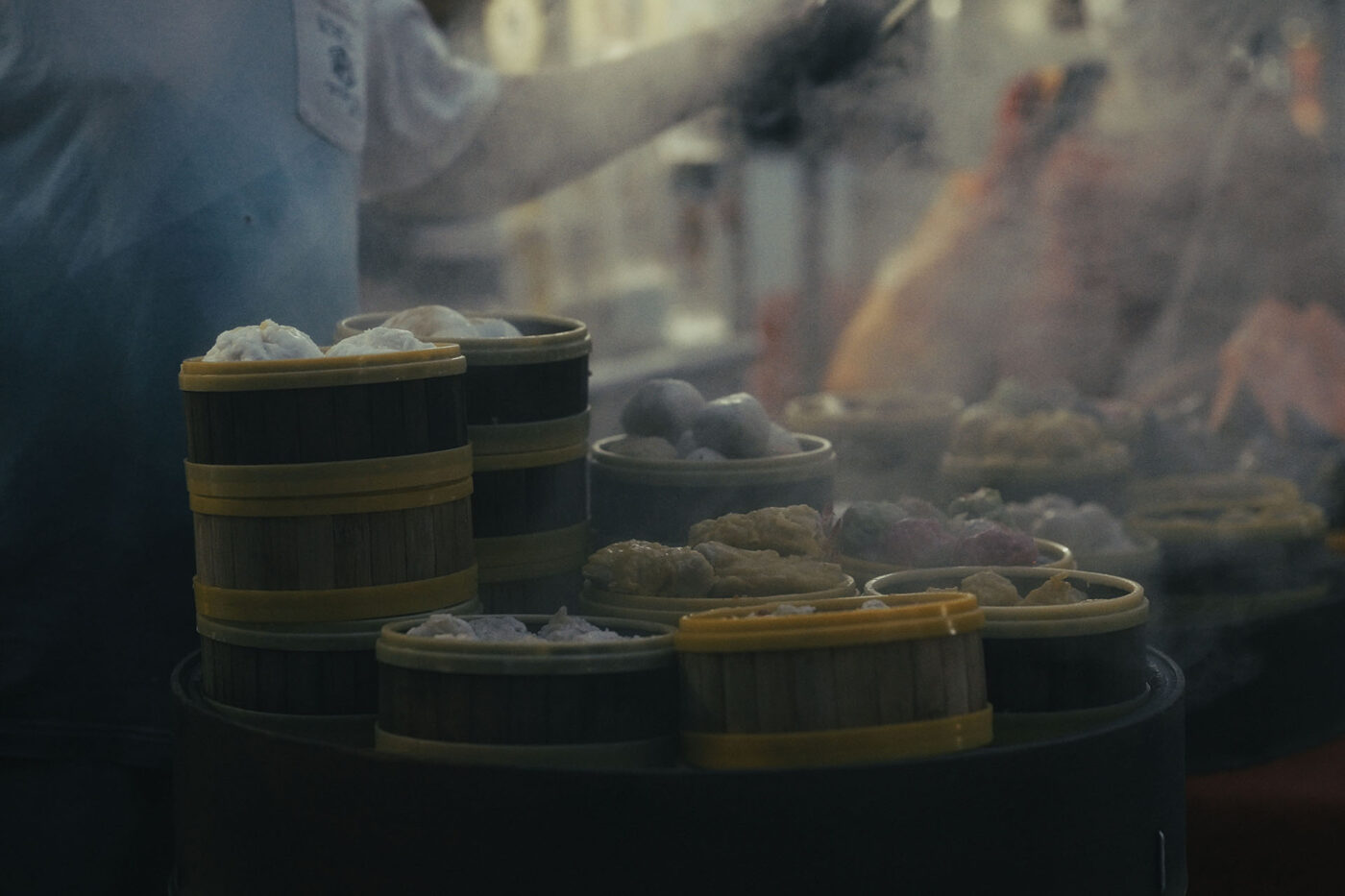 At least 10 steaming plates of dumplings.