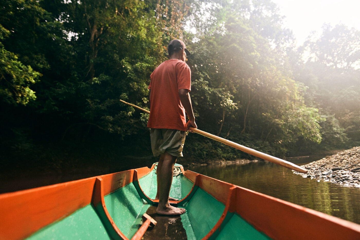 A man stand-up rowing in a boat.