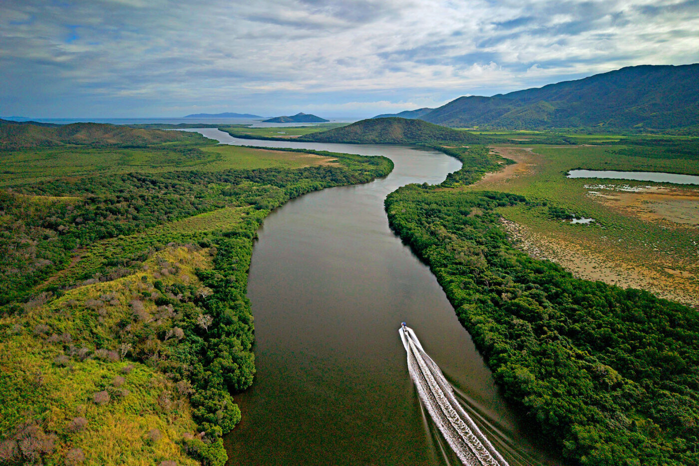 A speedboat going down a large river.