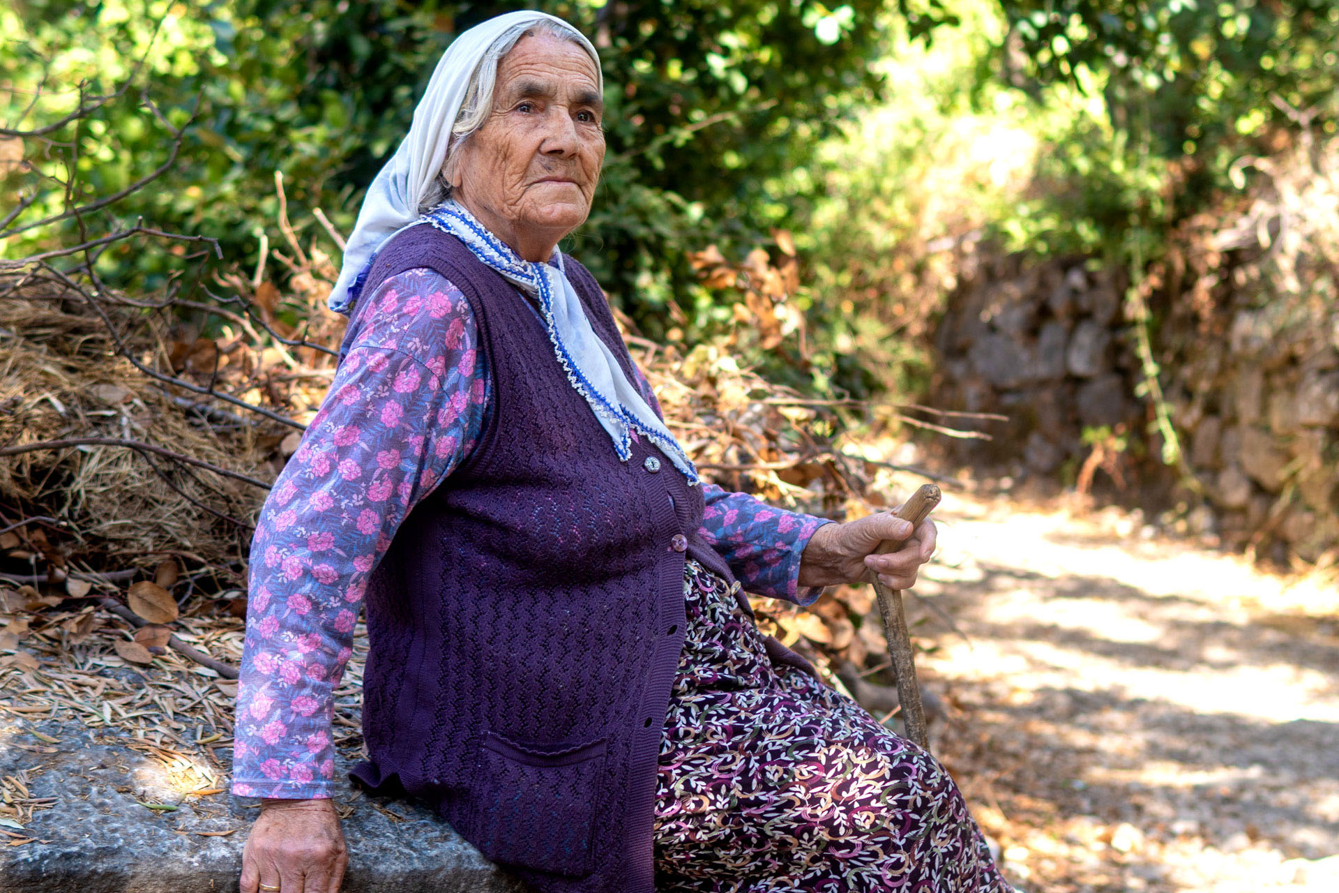 The mother from our homestay the previous night, sitting in Sidyma Ancient City.