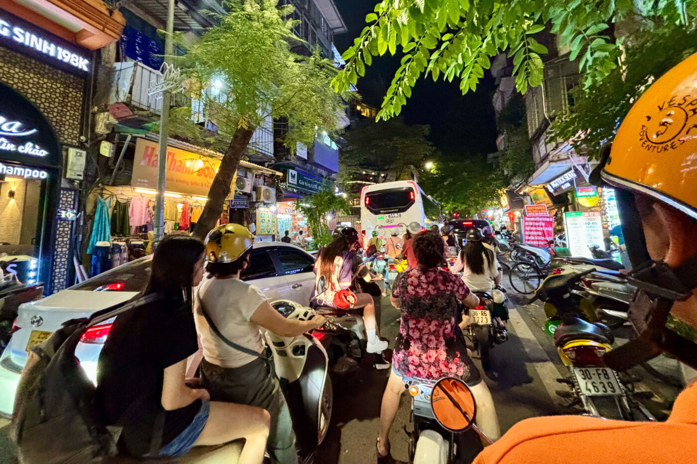 A big traffic jam of people on motorbikes and buses.